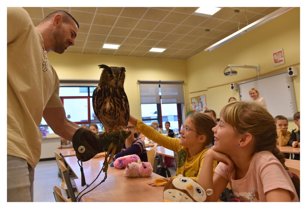 Uczennica klasy 2a głaszcze sowę.